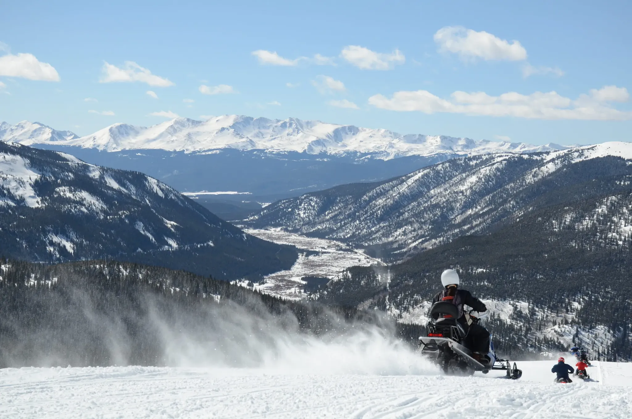 colorado rocky mountain snowmobile adventure with sweeping snowy mountain views 