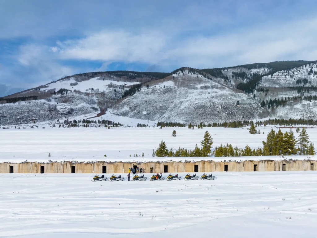 snowmobile group adventuring the the colorado rocky mountains