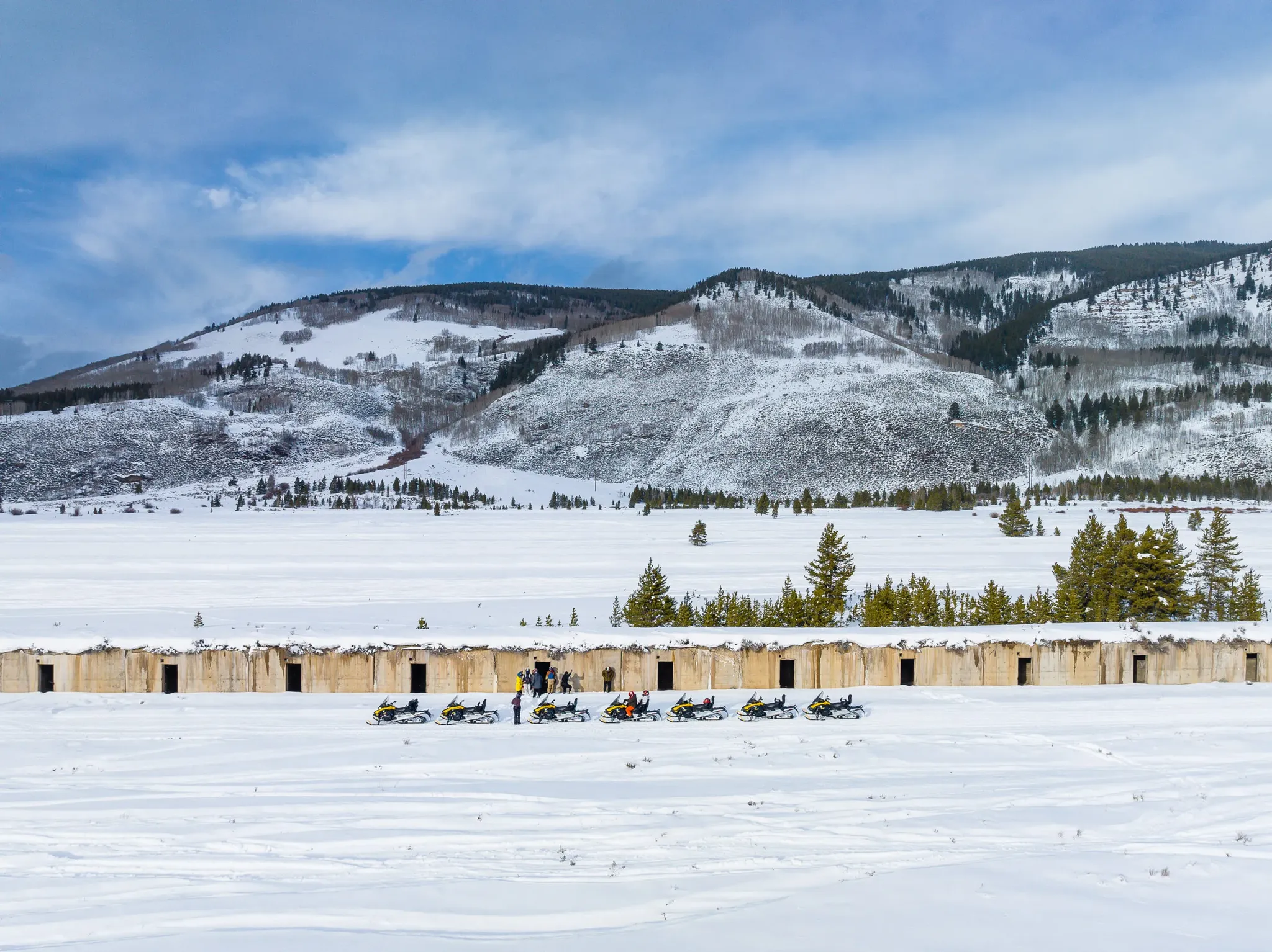 snowmobile group adventuring the the colorado rocky mountains