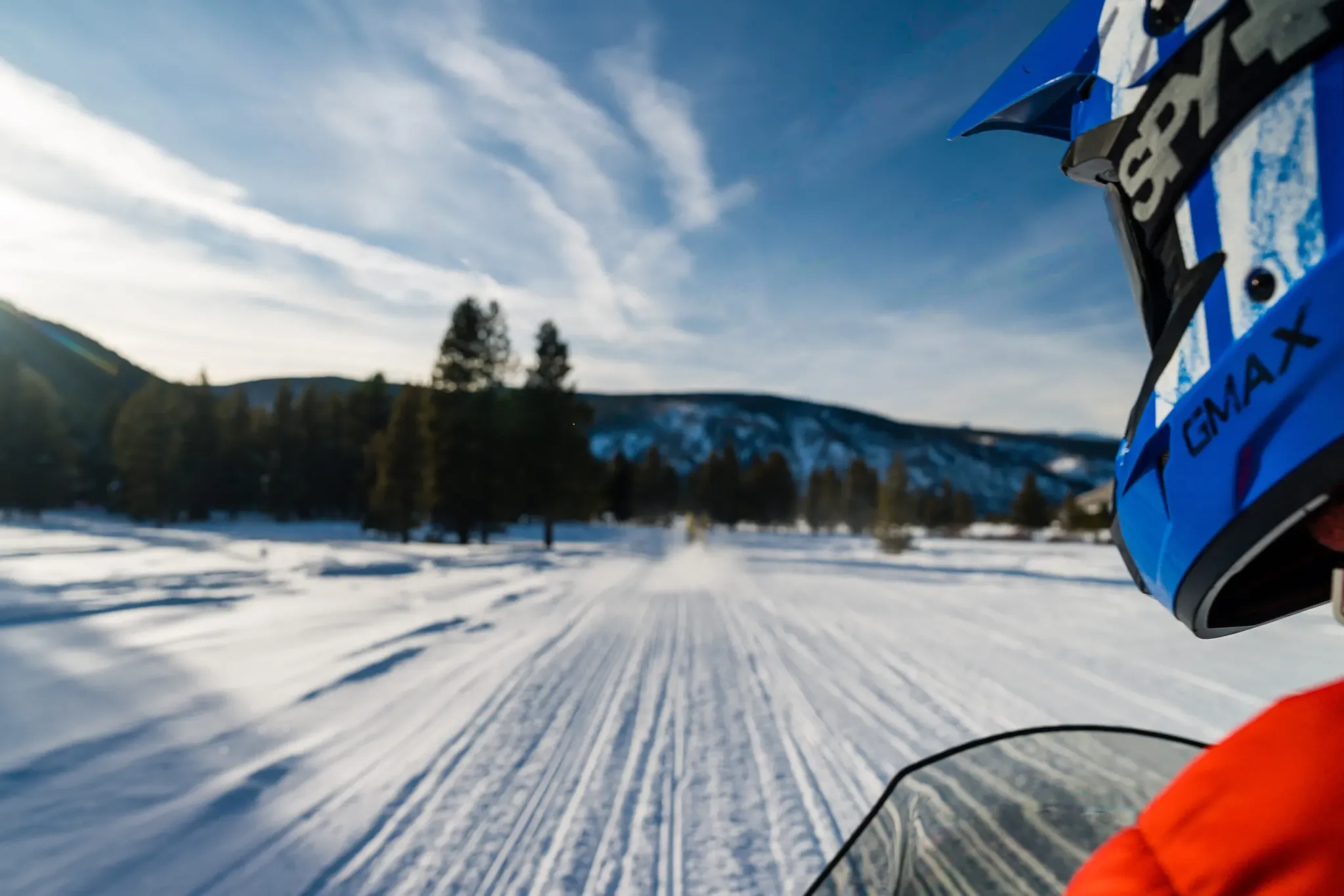 snowmobile rider on high adventure tour in snow landscape