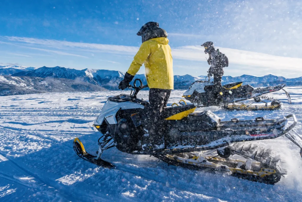rocky mountain snowmobilers with mountain views